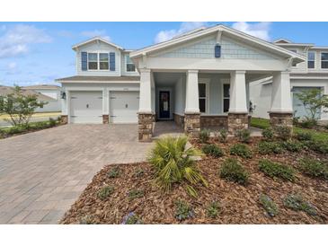 Charming two-story home with a welcoming front porch, manicured landscaping, and a two-car garage at 13200 Faro Ct # 44, Winter Garden, FL 34787