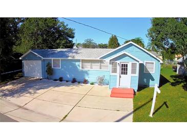 Cute blue house with a large yard, driveway and garage at 1632 Gar St, St Cloud, FL 34771