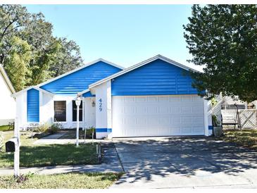 Cute blue house with white garage door and well-maintained lawn at 429 Copperstone Cir, Casselberry, FL 32707
