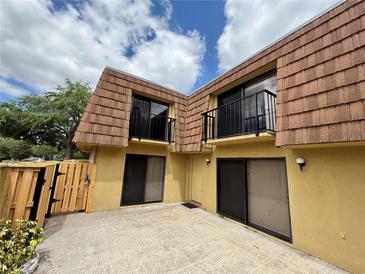 Inviting multi-story townhouse with balconies and private patio space in a sunny neighborhood at 5341 Bamboo Ct # 418, Orlando, FL 32811