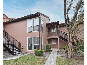 Exterior view of condo building with stairs and landscaping at 669 Grenadine Ct # S, Winter Park, FL 32792