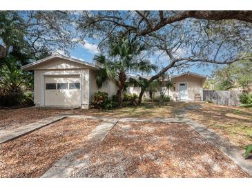 Home's exterior features a detached garage and grassy yard at 1 Black Jack Cir, Port Orange, FL 32128