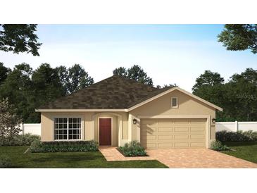 Tan one-story house with brown roof, red door, and two-car garage at 1568 Sky Lakes Dr, Saint Cloud, FL 34769