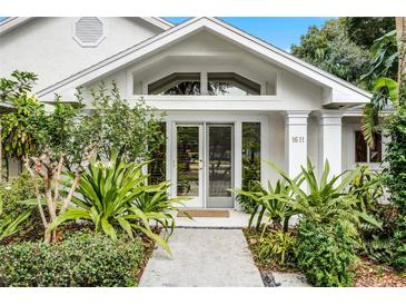 Inviting front entrance with lush landscaping and double doors at 1611 Walnut Ave, Winter Park, FL 32789