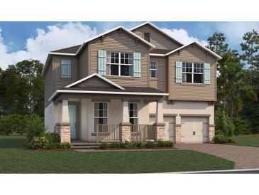 Two-story house with light brown siding, teal shutters, and stone accents at 16881 Muskgrass Dr, Winter Garden, FL 34787