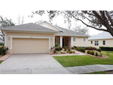 Charming single Gathering home with a well manicured lawn and a two car garage at 190 Crepe Myrtle Dr, Groveland, FL 34736