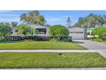 Charming ranch home with well-manicured lawn and attractive landscaping at 3306 Florene Dr, Orlando, FL 32806