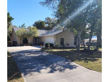 Single-story home with a driveway and landscaped lawn at 510 N Leavitt Ave, Orange City, FL 32763