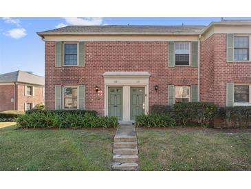 Brick front exterior of a charming two-story home with lush landscaping at 120 Georgetown Dr, Casselberry, FL 32707