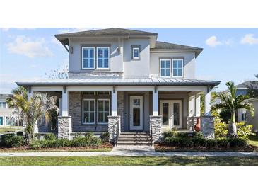 Two-story craftsman home with stone accents and metal roof at 13871 Briand Ave, Orlando, FL 32827