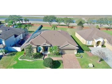 Beautiful single Gathering home featuring mature landscaping, attached two car garage, and brick paved driveway at 1855 Sugar Cove Ct, Ocoee, FL 34761