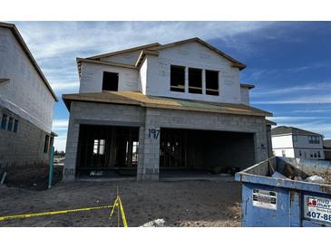 Two-story new construction home with gray siding and a three-car garage at 2678 Great Heron Ave, St Cloud, FL 34773