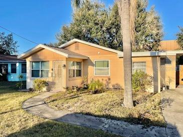 Tan single-story house with a walkway and palm tree at 770 Carver St, Winter Park, FL 32789