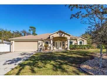 Charming single-story home with a well-manicured lawn, two-car garage, and covered front porch at 1715 Concert Rd, Deltona, FL 32738