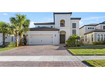 Two-story house with a two car garage and landscaped yard at 1861 Goblet Cove St, Kissimmee, FL 34746