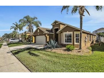 Well-maintained house with a two-car garage and attractive landscaping at 257 Bonville Dr, Davenport, FL 33897