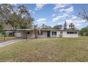 Ranch style home with carport, mature landscaping, and spacious yard at 3107 S Park Ave, Sanford, FL 32773