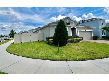 Well maintained home with green lawn, landscaping and a brick paver driveway leading to a two-car garage at 3333 Wauseon Dr, St Cloud, FL 34772