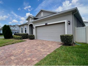 Well maintained home with a brick paver driveway, mature landscaping and a two car garage at 3333 Wauseon Dr, St Cloud, FL 34772