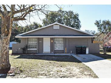 Gray single story house with a white door and attached garage at 3362 Janet St, Apopka, FL 32712