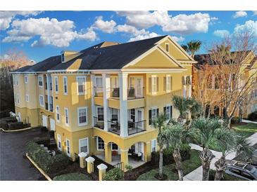 Attractive yellow 3-story building with balconies and landscaping at 3593 Conroy Rd # 413, Orlando, FL 32839