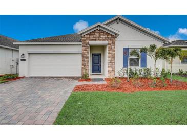 One-story home with stone accents and a two-car garage at 6324 Chirpine Ln, Saint Cloud, FL 34771