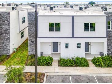 Modern townhouses with grassy yards and parking at 653 Trikomo Dr, Davenport, FL 33896