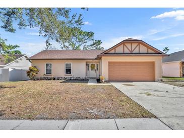 Inviting single-story home with attached garage and well-maintained lawn at 1004 Chance Cv, Oviedo, FL 32765