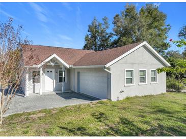 Single story home with attached garage and landscaped yard at 1480 Battle St, Oviedo, FL 32765