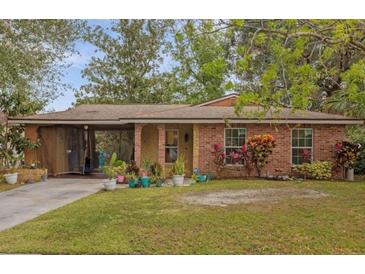 Brick house with a landscaped yard and driveway at 1783 Flores Ct, Orlando, FL 32811