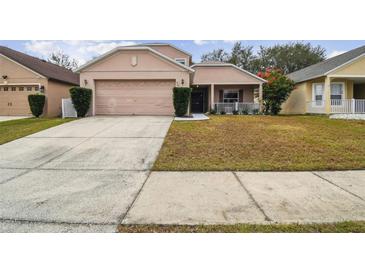 Two-story house with attached garage and landscaping at 2058 Newtown Rd, Groveland, FL 34736