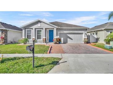 Curb appeal abounds in this charming one-story home featuring a welcoming front porch and neatly landscaped yard at 2950 Sonata Ct, Saint Cloud, FL 34772