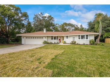 Charming ranch home with updated brick exterior, new landscaping, and a spacious yard at 332 Lake Winnemissett Dr, Deland, FL 32724