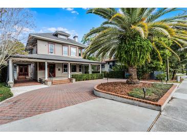 Large two-story house with a wrap-around porch and brick driveway at 567 Osceola Ave, Winter Park, FL 32789