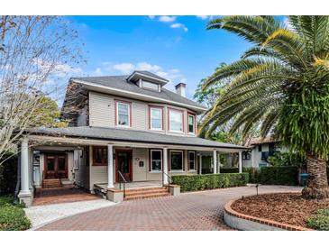 Charming two-story home with a large front porch and brick driveway at 567 Osceola Ave, Winter Park, FL 32789