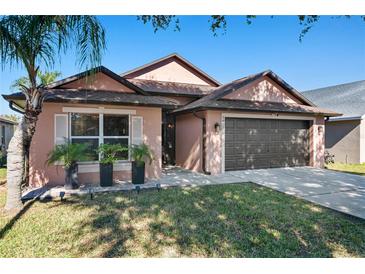 Attractive one-story home with a two-car garage and well-manicured lawn at 7927 Oakstone Ct, Orlando, FL 32822