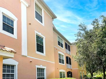 A view of the exterior of the building, with multi-level units and manicured landscaping at 13536 Turtle Marsh Loop # 538, Orlando, FL 32837