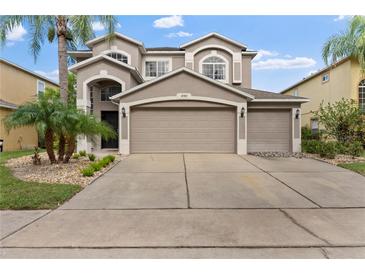 Two-story house with a large driveway and landscaped front yard at 14742 Masthead Landing Cir, Winter Garden, FL 34787