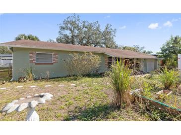 Ranch style home with mature landscaping and a spacious yard at 1613 Oriole Ave, Orlando, FL 32803