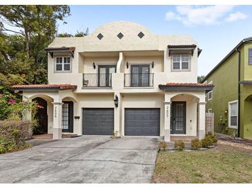 Two-story duplex with Spanish-style architecture, featuring two attached garages at 2607 E Jefferson St, Orlando, FL 32803