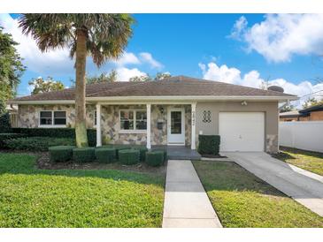 Charming ranch home with stone exterior, spacious yard, and a two-car driveway at 2842 Eastern Pkwy, Winter Park, FL 32789