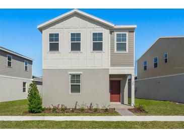 Two-story house with gray siding, red door, and small front yard at 360 Belmond Dr, Debary, FL 32713