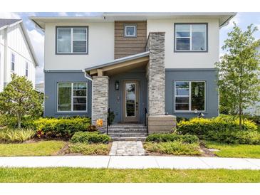 Two-story home with stone accents and landscaped front yard at 6921 Arnoldson St, Orlando, FL 32827