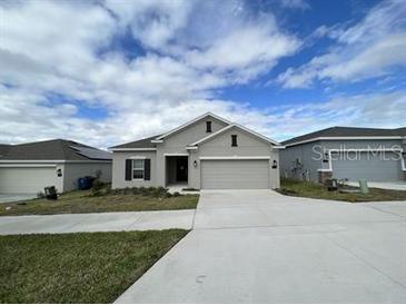 New single-story home with attached garage and neutral exterior at 807 Ofanto Way, Haines City, FL 33844