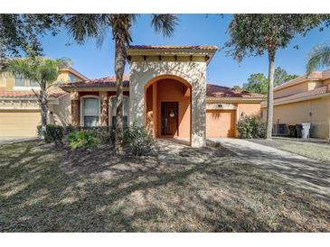 Beautiful one-story house with a terracotta roof and lush landscaping at 334 Orange Cosmos Blvd, Davenport, FL 33837