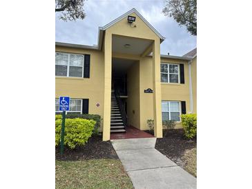 Condo building exterior with stairs and landscaping at 2047 Dixie Belle Dr # 2047S, Orlando, FL 32812