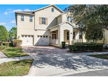 Two-story house with attached garage and manicured landscaping at 8729 Eden Cove Dr, Winter Garden, FL 34787