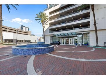 Elegant building entrance with fountain and brick pavers at 150 E Robinson St # 14A, Orlando, FL 32801