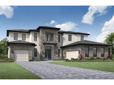 Two-story home with stone accents and a three-car garage at 17308 Pesce Loop, Montverde, FL 34756