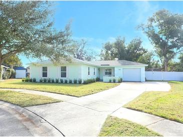 Light teal single story home with well manicured lawn and driveway at 30 Old Barn Way, Casselberry, FL 32707